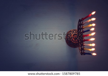 Religion image of jewish holiday Hanukkah background with brass menorah (traditional candelabra) and candles. top view