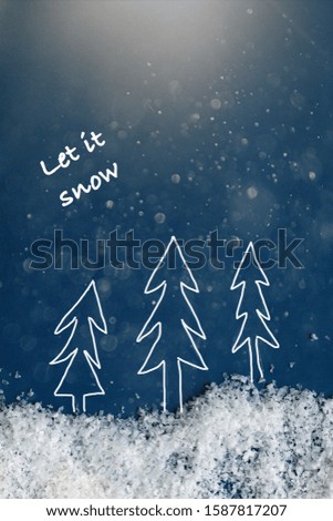 Christmas tree glowing silhouette with snow, blue background, empty space for text, selective focus