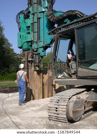 Worker in front of large machine