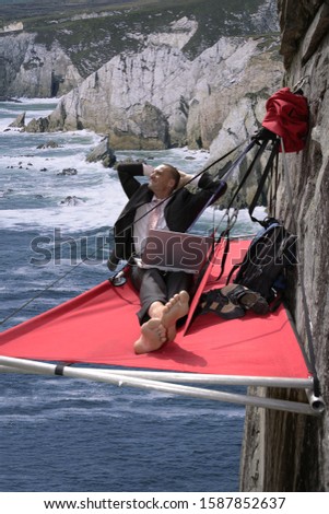 Businessman using a computer and hanging over beach