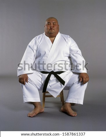 Portrait of a martial arts student sitting on a stool