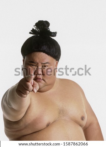 Portrait of a sumo wrestler pointing