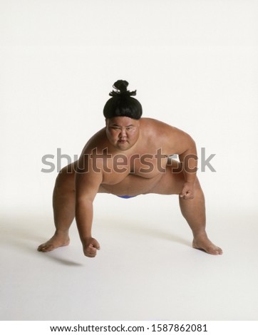 View of a sumo wrestler squatting Royalty-Free Stock Photo #1587862081