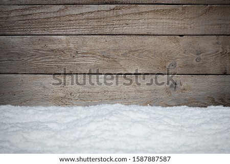 WOODEN BOARDS WITH WINTER SNOW