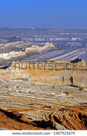 The beautiful landscape of the surface mine. Incredible geological forms. The amazing appearance of the devastated land created by digging excavators.