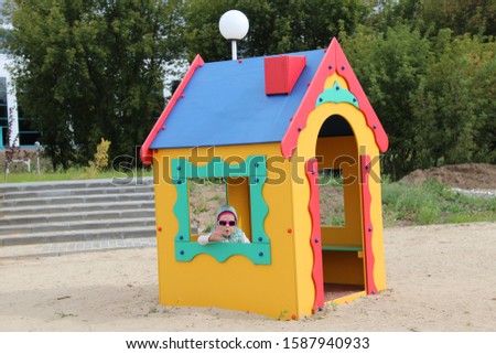 girl plays on the playground. Sandbox House