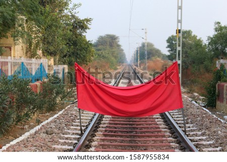 Piece of red cloth blocking the movement of a train.  Prohibition of train movement. Coronavirus. Haryana, India