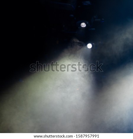 Theater lights spotlights and smoke over the stage, texture background for design.