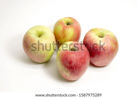 Ripe juicy red-green apples on a white background. Close up. Selective focus.