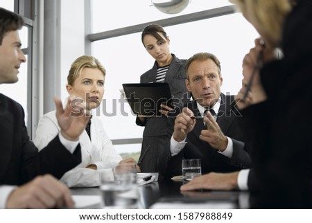Businesspeople having meeting at conference table