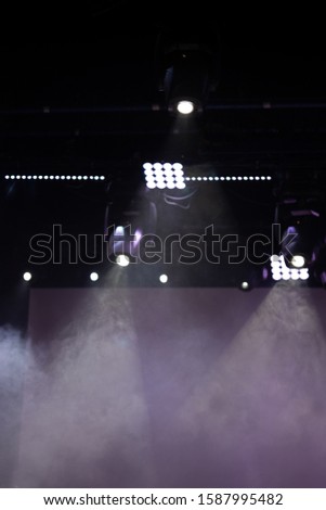 Theater lights spotlights and smoke over the stage, texture background for design.