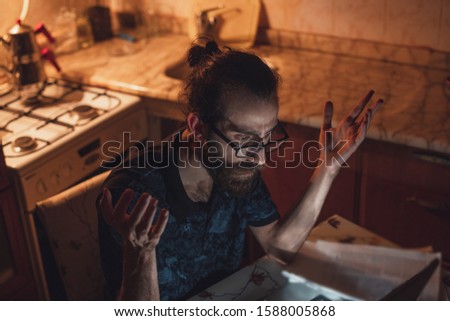 Frustrated man having troubles to pay the bills