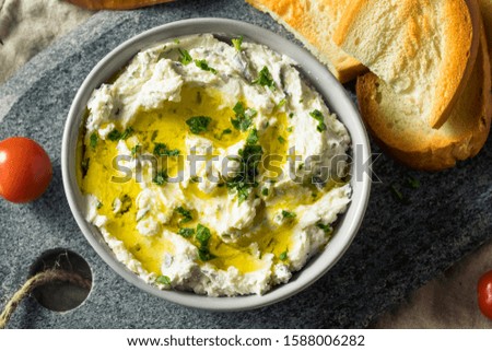 Homemade Herby Goat Cheese Dip with Toast and Tomato Royalty-Free Stock Photo #1588006282