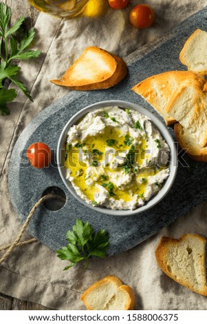 Homemade Herby Goat Cheese Dip with Toast and Tomato Royalty-Free Stock Photo #1588006375