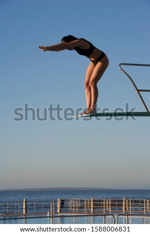 A woman diving into a pool