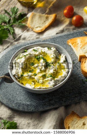 Homemade Herby Goat Cheese Dip with Toast and Tomato Royalty-Free Stock Photo #1588006906
