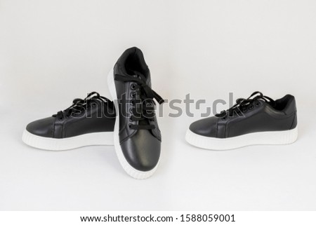 black leather sneakers shoes isolated on white background side and front view