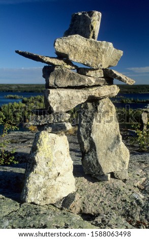 Cairn or stone man or inukshuk at the Hidden Lakes, Ingraham Trail, Northwest Territories, Canada Royalty-Free Stock Photo #1588063498