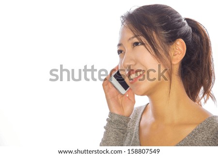Asian young woman on a phone cellphone iPhone talking calling long distance