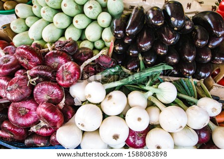 Open market shelves full of a different kinds of vegetables