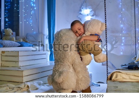 boy with stuffed toy bear in christmas setting