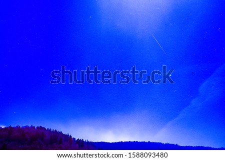 Geminid meteors or Geminid shooting stars in the night sky.
