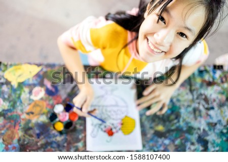 Top view,happy asian female people enjoy paint activities having fun,relax, smiling teenage girl with palette and paintbrush to painting watercolor on canvas, art,creativity,development of children