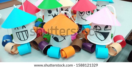 The art of bringing together colored paper and paper glasses to create a cartoon with beautiful colors. Funny. Smile to the spectators.