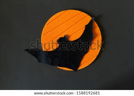 Halloween image concept. Bat on orange background
