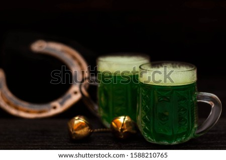 St. Patrick Day concept. Glasses of green beer. On dark table