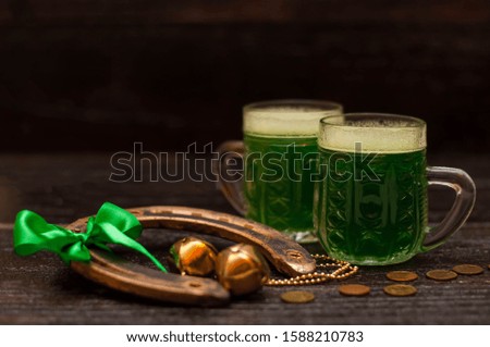 St. Patrick Day concept. Glasses of green beer. On dark table
