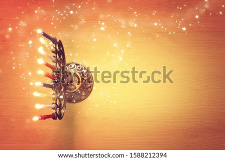 Religion image of jewish holiday Hanukkah background with brass menorah (traditional candelabra) and candles. top view
