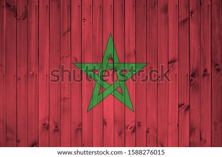 Morocco flag depicted in bright paint colors on old wooden wall. Textured banner on rough background