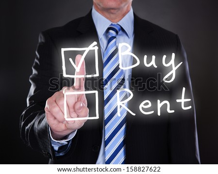 Businessman selecting buy option on the screen over black background
