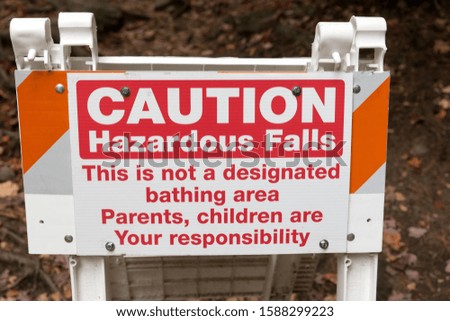 Sign saying: Caution hazardous falls. This is not a designated bathing area. Parents, children are your responsibility