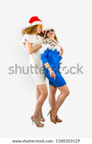 Happy laughing women in Santa hats having fun isolated on gray backdrop Happy New Year 2020 celebration holiday concept. Mock up copy space.