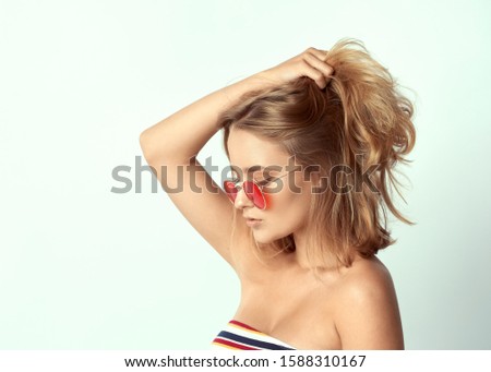 young girl in glasses, beautiful and healthy skin, natural blond hair, empty background, delicate makeup