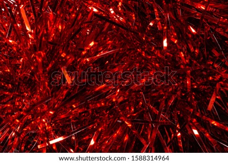 Christmas background, texture of red shiny tinsel