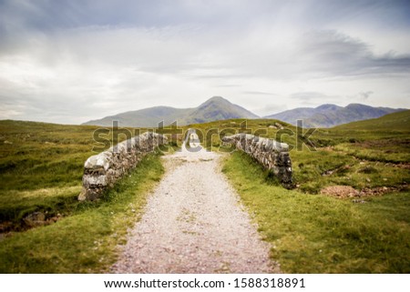 Bridge to the mountains - West Highland Way Royalty-Free Stock Photo #1588318891