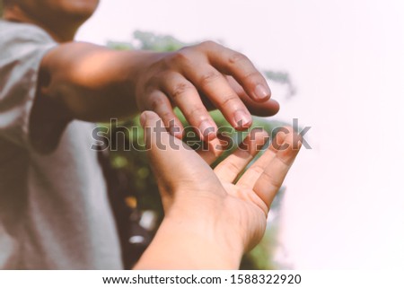 Help Concept hands reaching out to help each other