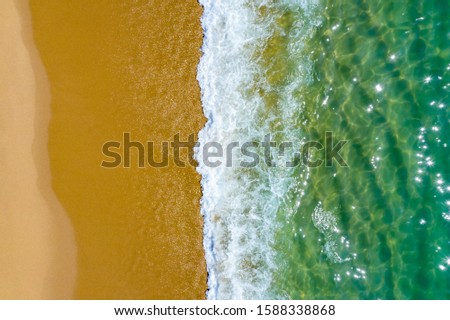 Tropical beach water background. Soft wave of emerald clear sea on sandy beach