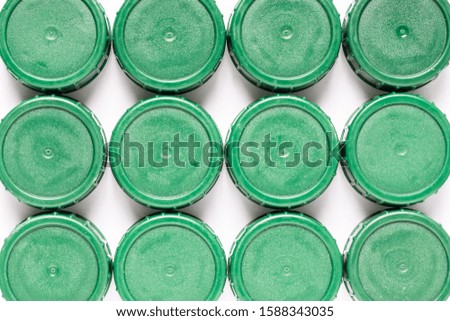 Green plastic bottle caps in a row
