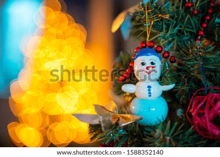 Decorated Christmas Tree on Blurred, Sparkling and Fairy Background, Toy of Snowman