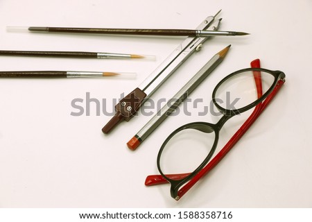 drawing equipment compasses, brushes and glasses