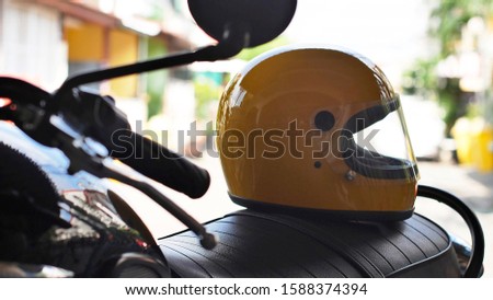 Yellow motorcycle helmet on the seat of a motorcycle