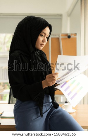 Arabic businesswoman wearing hijab Work in the office with pleasure in a natural office atmosphere.