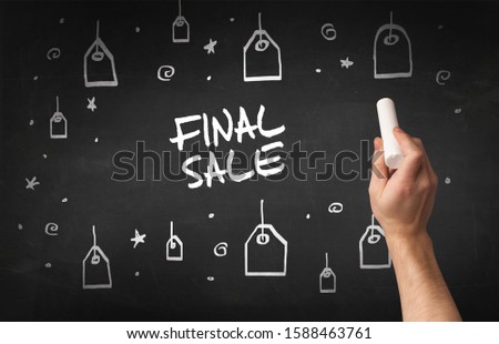 Hand drawing FINAL SALE inscription with white chalk on blackboard, online shopping concept
