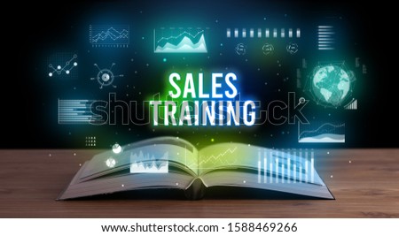 SALES TRAINING inscription coming out from an open book, creative business concept