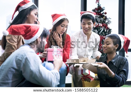 group of young employees celebrate the new year together in the office.