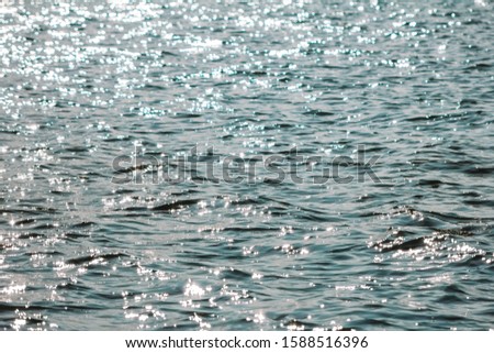 water texture with sun flare, small waves